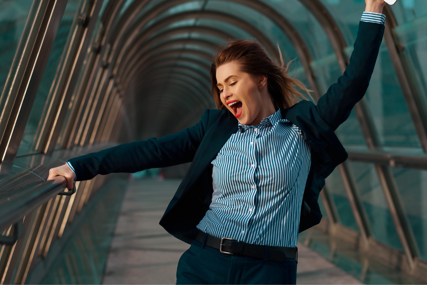Cheerful business woman with digital tablet feeling carefree after finding a better job